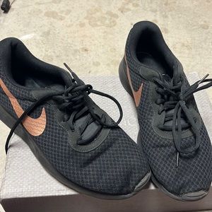 Rose gold and black Nike shoes